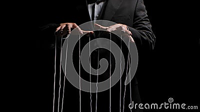 Man hands with strings on fingers on black background. Violence, harassment, bullying concept. Master in business suit Stock Photo