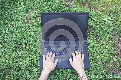 Man hands typing on laptop in outdoor. Stock Photo