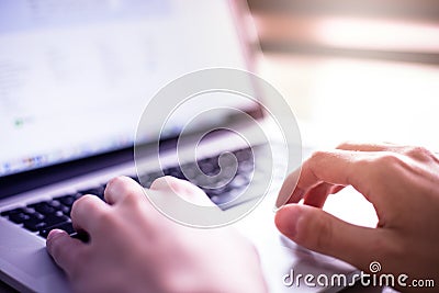 Man hands using laptop on desk Stock Photo