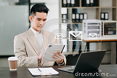 Man hands using Laptop, tablet typing and surfing the internet with email icon, email marketing concept, send e-mail or newsletter Stock Photo