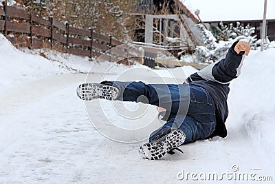 A man has slipped and has fallen down Stock Photo