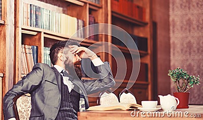 Man has terrible headache. Bearded man in formal suit suffers from negative thoughts and looks unsatisfaied. Mature man Stock Photo