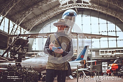 Funny man in airplanes museum. Editorial Stock Photo