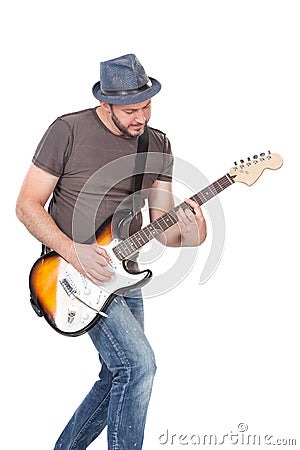 Man with hat and beard play on electric guitar with enthusiasm. Isolated on white Stock Photo