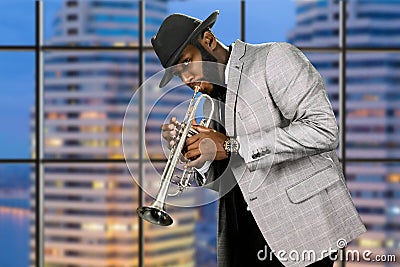 Man in hat playing trumpet. Stock Photo