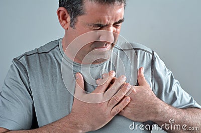 Man having acute pain in a his chest Stock Photo
