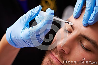 Man Having Botox Treatment At Beauty Clinic Stock Photo