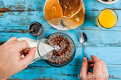 Man having breakfast with cereal chocolate balls Stock Photo