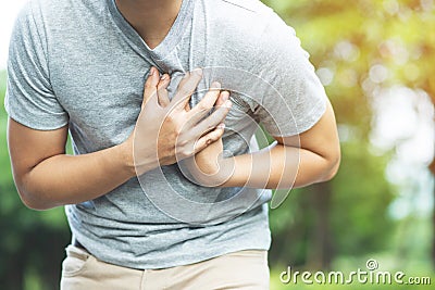 Man having chest pain - heart attack outdoors. Stock Photo