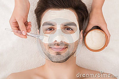 Man having cosmetic mask in spa salon Stock Photo