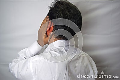 Man having ear pain touching his painful inflamed ear isolated on white background Stock Photo