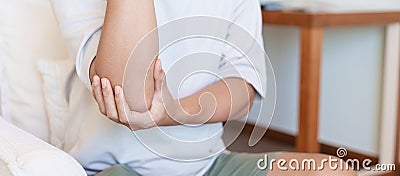 Man having elbow ache and muscle pain due to lateral epicondylitis or tennis elbow. injuries and medical concept Stock Photo