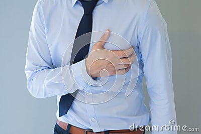 Man having heart-attack / chest pain in isolated background Stock Photo