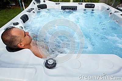 Man having massage in hot tub spa. Stock Photo