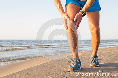 Man having a pain in his knee Stock Photo