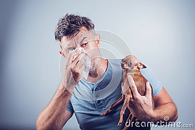 Man having pet allergy symptoms : runny nose, asthma Stock Photo