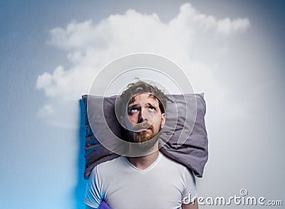 Man having problems/ insomnia, laying in bed on pillow Stock Photo