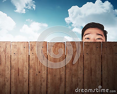 A man head behind wooden fence Stock Photo