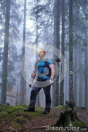 Man with headlamp and backpack in the forest Stock Photo