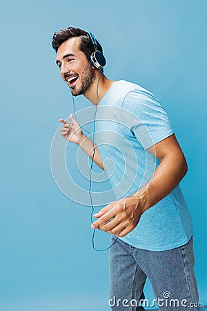 Man headphone space copy sing studio online fun music t-shirt lifestyle blue portrait happy Stock Photo