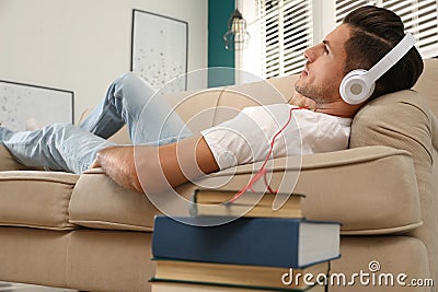 Man with headphones with book Stock Photo