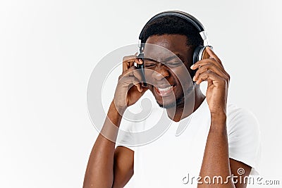 man in headphones listening to music emotions white t-shirt studio fun Stock Photo