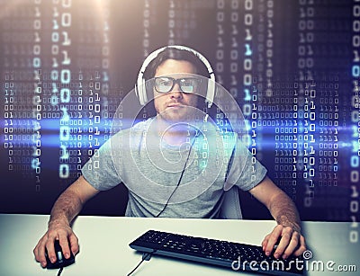 Man in headset hacking computer or programming Stock Photo