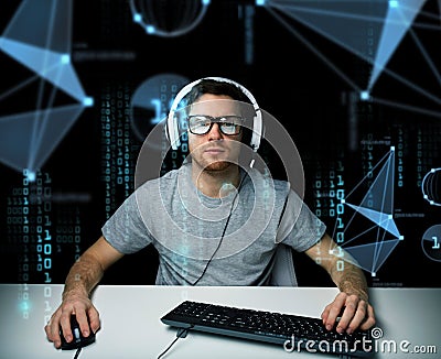 Man in headset hacking computer or programming Stock Photo