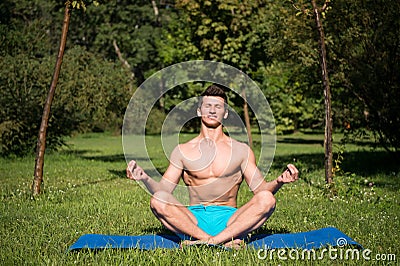 Man with healthy body meditate on yoga mat Stock Photo