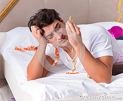 Man after heavy christmas partying at home Stock Photo