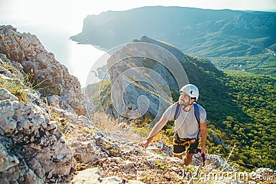 Man climbing mountain. Stock Photo