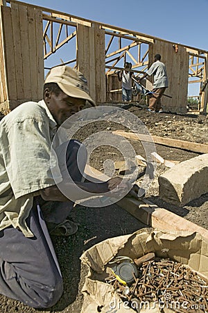 Man helps construct new houses for Pepo La Tumaini Jangwani, HIV/AIDS Community Rehabilitation Program, Orphanage & Clinic. Pepo Editorial Stock Photo