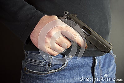 The man hid the gun behind their backs, robbery, crime, kidnapping Stock Photo