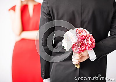 Man hiding bouquet of flowers Stock Photo