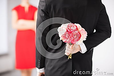 Man hiding bouquet of flowers Stock Photo