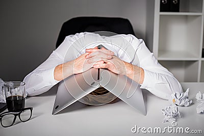 Man hiding under laptop Stock Photo