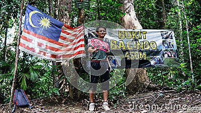 Man hiker arrived at the peak of Wave Rock at Bukit Baginda Majau in Negeri Sembilan. Editorial Stock Photo