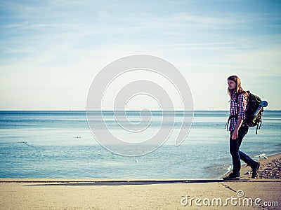 Man hiker with backpack tramping by seaside Stock Photo