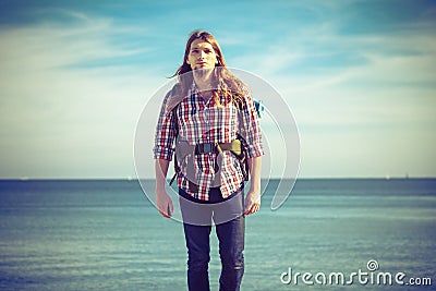 Man hiker with backpack tramping by seaside Stock Photo