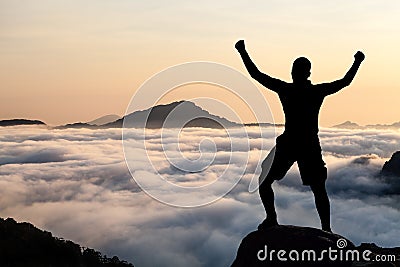 Man hiking climbing silhouette in mountains Stock Photo