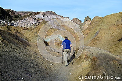 Man Hiking Death Valley's Colorful Artists Palette Stock Photo
