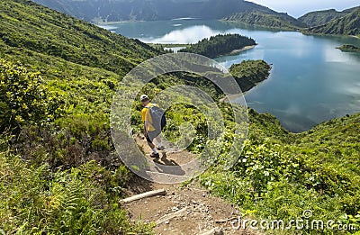 Man Hiking down to Lagoa do Fogo In Sao Miguel Azores Stock Photo