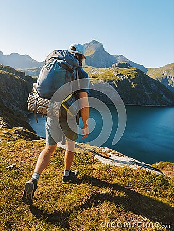 Man hiking solo with backpack in Norway mountains travel outdoor active summer vacations healthy lifestyle Stock Photo