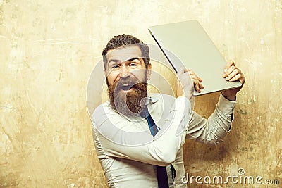 Man or hipster with long beard hold laptop, overwork Stock Photo