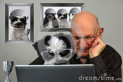 Man and dog looking at football results in internet Stock Photo