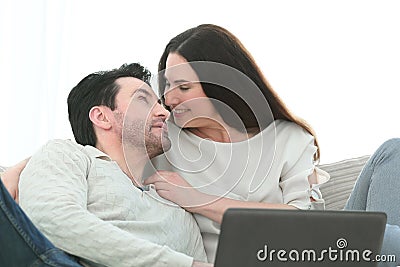 Man with his girlfriend chatting on laptop at home indoor Stock Photo