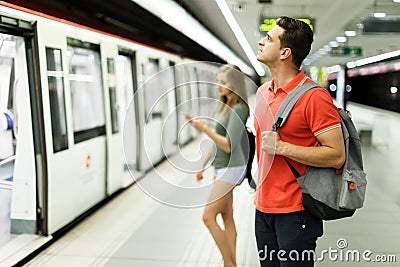 Man with his girlfriend are standing on platform and choosing route Stock Photo