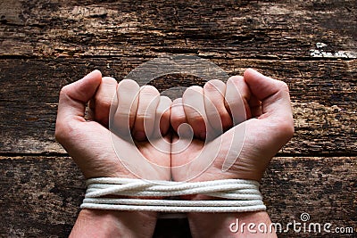 Man with his hand tied demonstrates that he is a slave Stock Photo