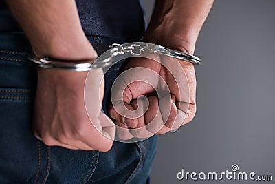 The man with his hands handcuffed in criminal concept Stock Photo