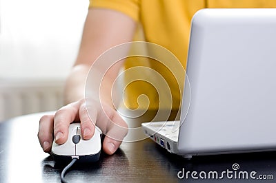 Man with his right hand on the mouse Stock Photo